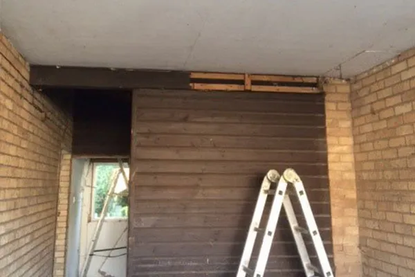 An Image of a damaged ceiling panel which is being fixed